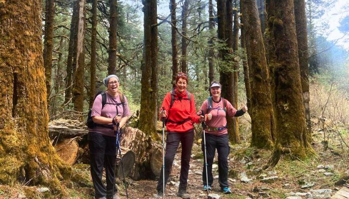 Happy group trekking through forest in Nepal