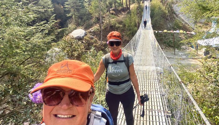 Walking over a suspension bridge in the Himalayas Nepal